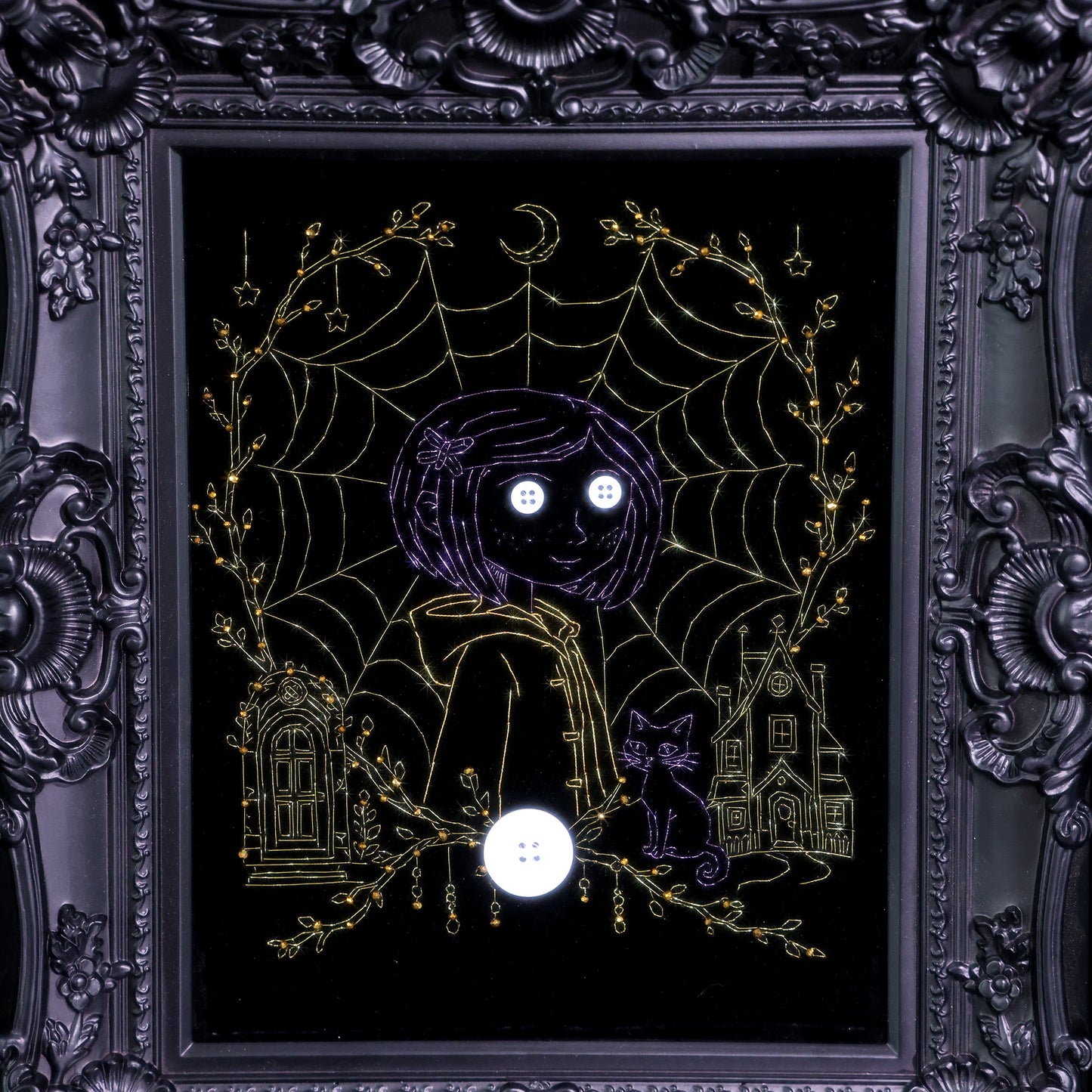 10 inches Original Coraline-themed embroidered wall art on black velvet with metallic thread, rhinestones, and button eyes in an ornate black frame. Handmade, ready to hang. Contains handmade embroidered decorative paintings.