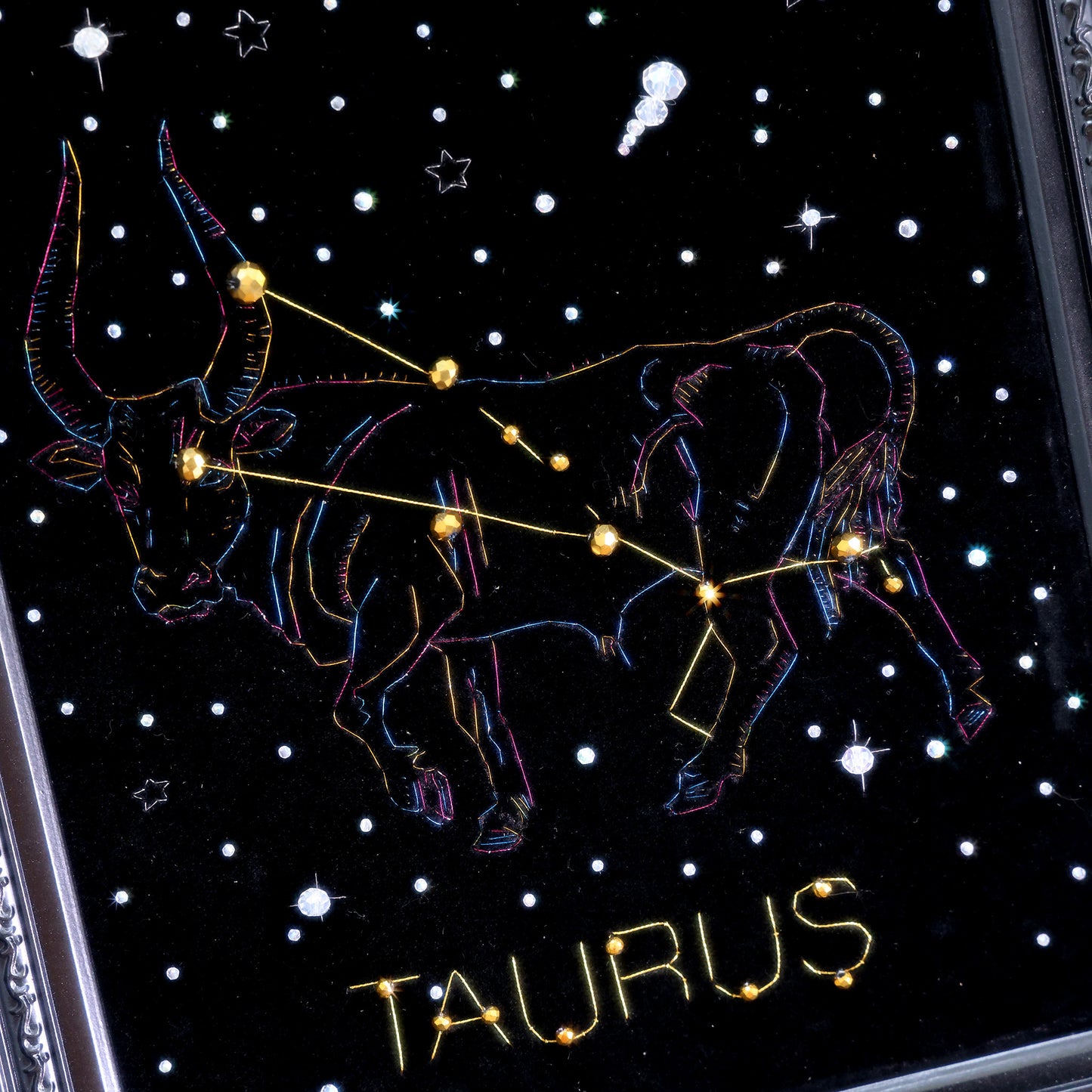 10 Inches  Hand-stitched Taurus constellation embroidery on black velvet with metallic thread and rhinestone accents, set in an ornate matte-black resin frame — ready to hang.