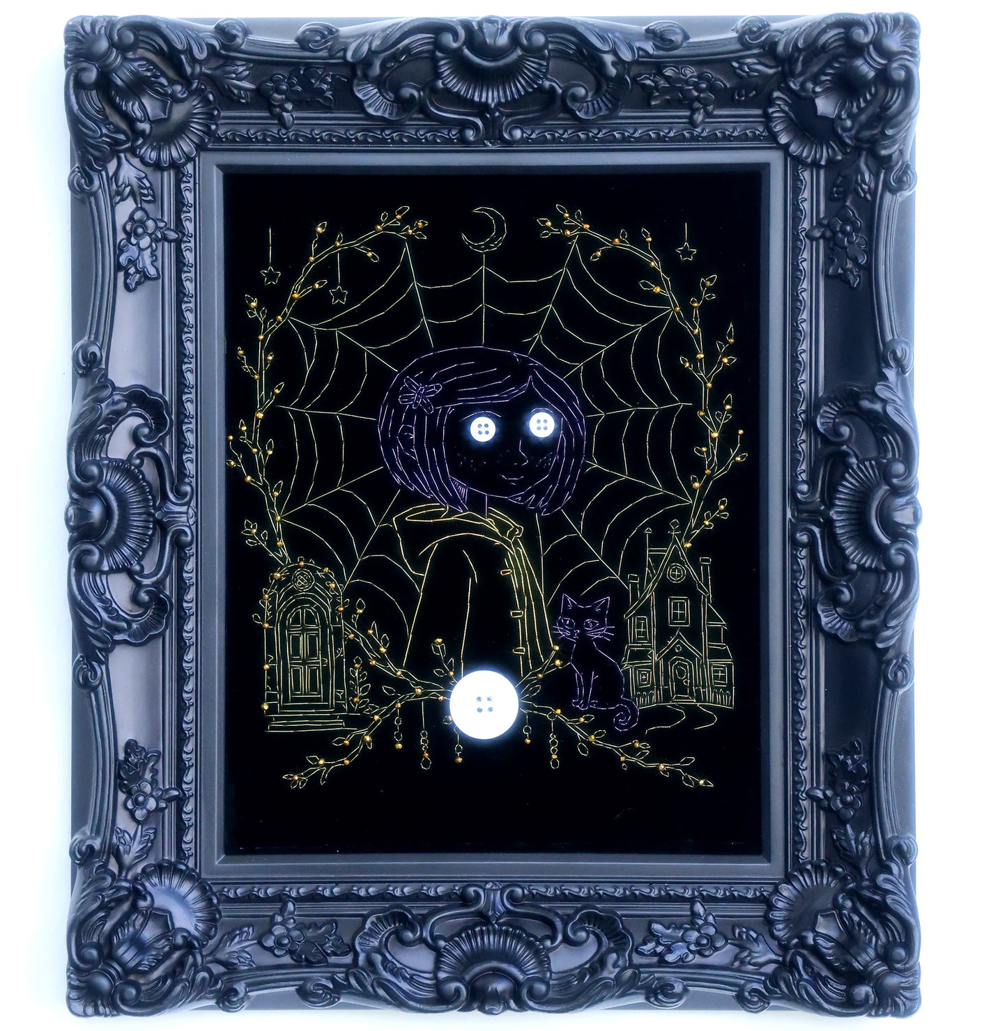 10 inches Original Coraline-themed embroidered wall art on black velvet with metallic thread, rhinestones, and button eyes in an ornate black frame. Handmade, ready to hang. Contains handmade embroidered decorative paintings.