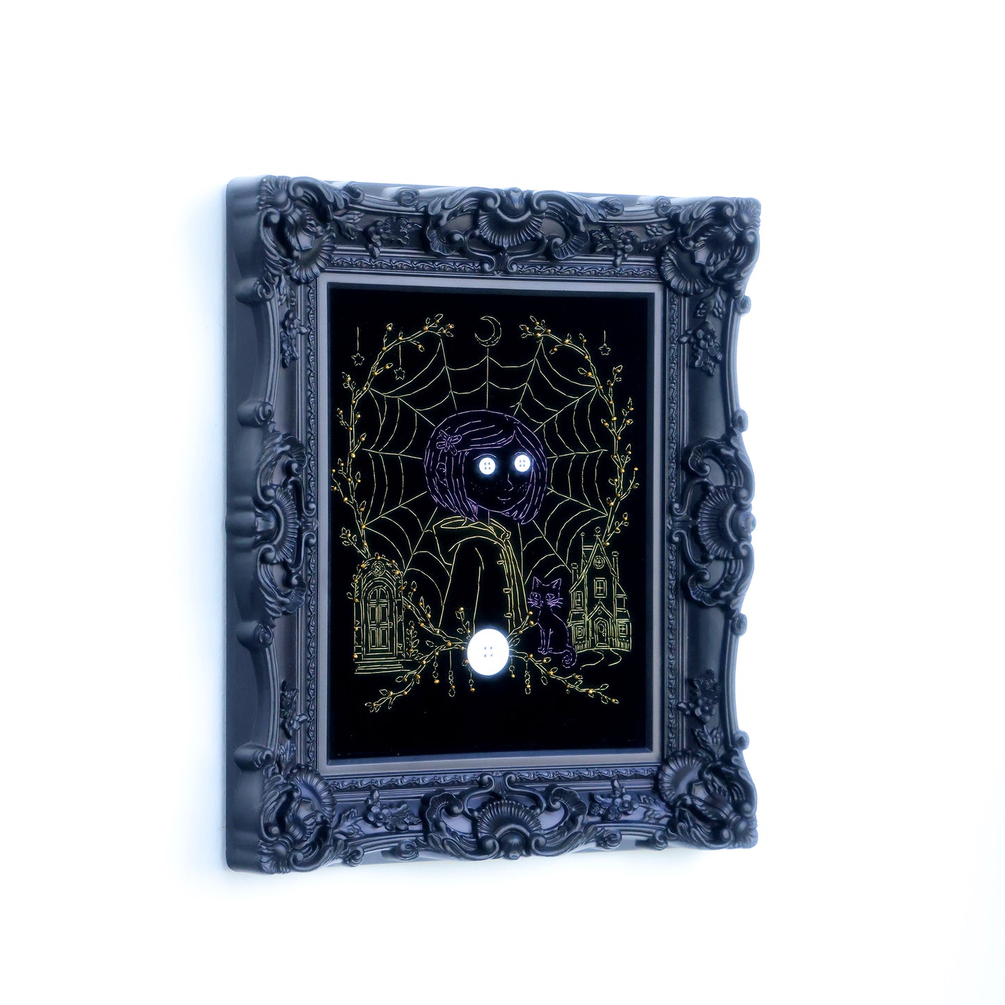 10 inches Original Coraline-themed embroidered wall art on black velvet with metallic thread, rhinestones, and button eyes in an ornate black frame. Handmade, ready to hang. Contains handmade embroidered decorative paintings.