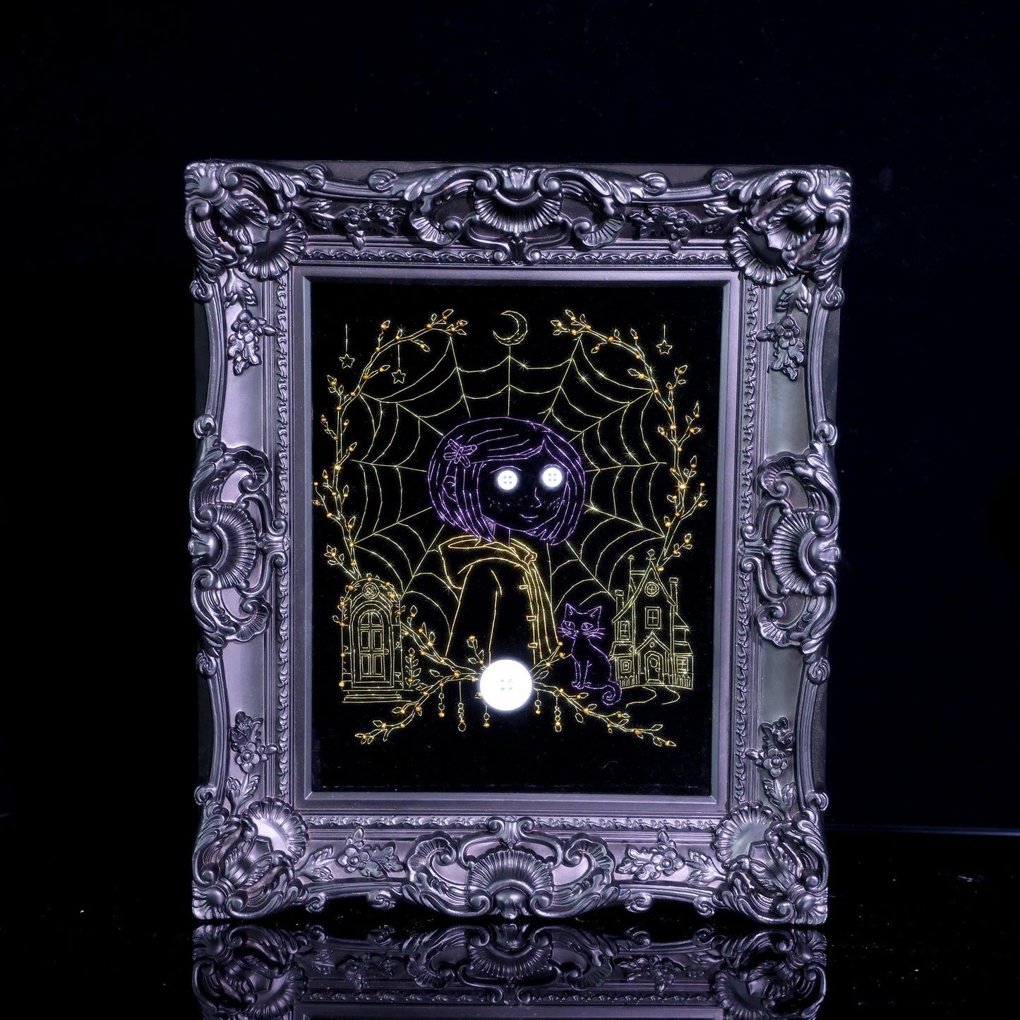 10 inches Original Coraline-themed embroidered wall art on black velvet with metallic thread, rhinestones, and button eyes in an ornate black frame. Handmade, ready to hang. Contains handmade embroidered decorative paintings.