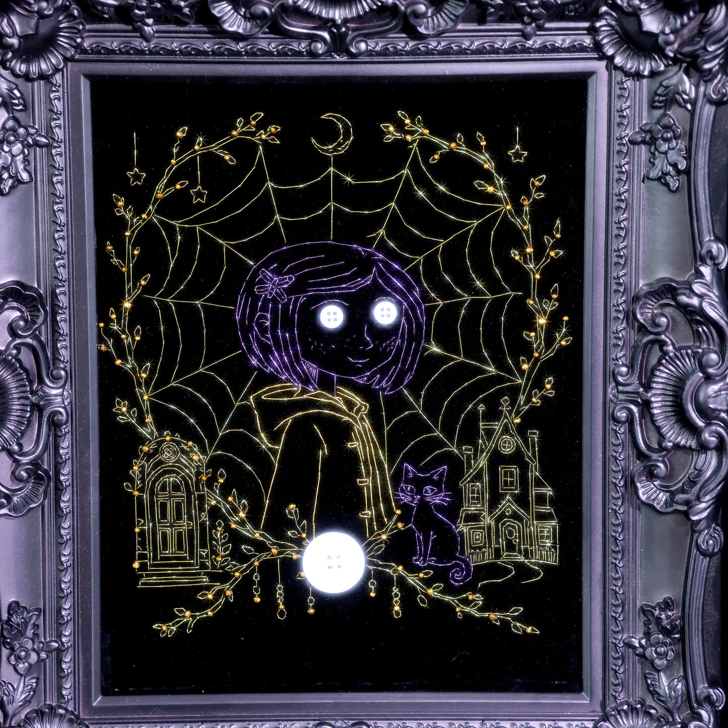 10 inches Original Coraline-themed embroidered wall art on black velvet with metallic thread, rhinestones, and button eyes in an ornate black frame. Handmade, ready to hang. Contains handmade embroidered decorative paintings.