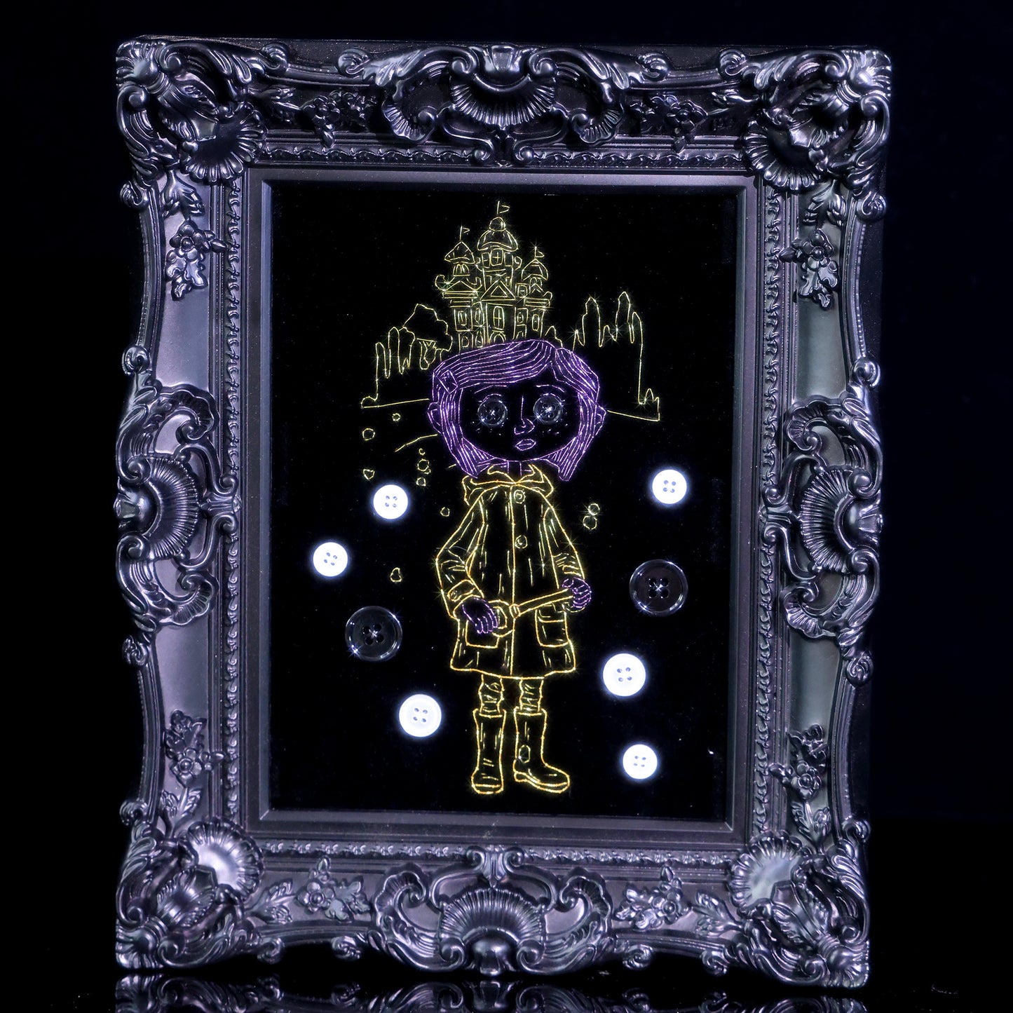 8 inches Handmade Coraline-inspired embroidered wall art on black velvet with metallic thread, buttons, and rhinestone accents in a matte ornate black frame — intentionally unglazed to showcase texture. Contains handmade embroidered decorative paintings.