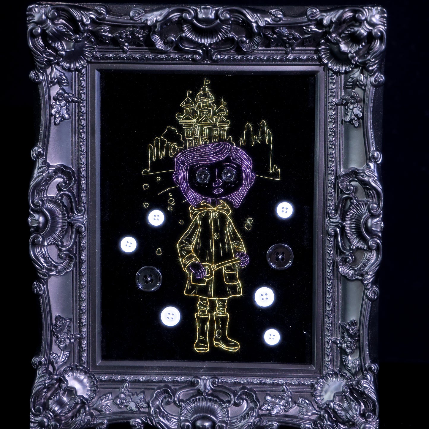 8 inches Handmade Coraline-inspired embroidered wall art on black velvet with metallic thread, buttons, and rhinestone accents in a matte ornate black frame — intentionally unglazed to showcase texture. Contains handmade embroidered decorative paintings.